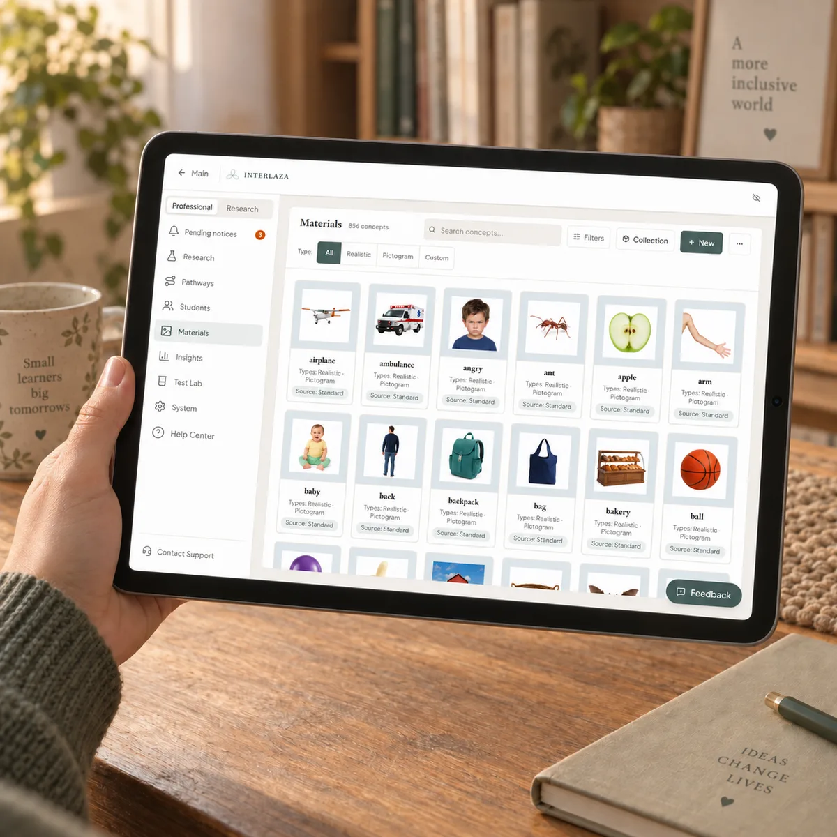 A tablet held in one hand showing the Interlaza library: the filter panel on the left and a grid of concept cards with photographs